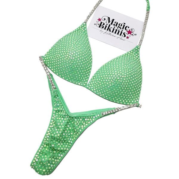 Competition Bikini No.203 – Eye-catching mint green lycra bikini, covered in stunning Green AB crystals. Features elegant triple-row silver metal diamanté neck and hip connectors for a glamorous stage look. Perfect for NPC/PCA competitions.