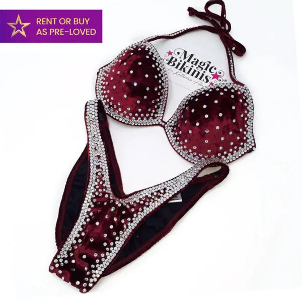 Hot Berry IFBB Elite Pro bikini in rich burgundy velvet with clear crystal rhinestones — available to rent or buy pre-loved from Magic Bikinis.